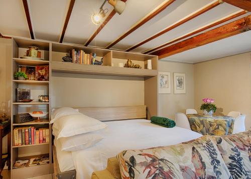 a bedroom with a bed and a book shelf at Elsewhere Treehouse and Apartment on the River in Muldersdrift