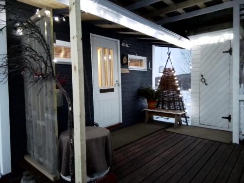 a porch with a christmas tree on it at Experience accommadation Eco-Unela in Rovaniemi