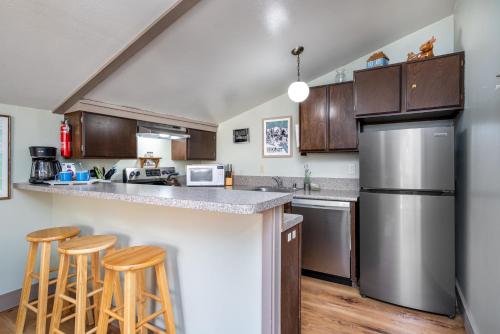 a kitchen with stainless steel appliances and wooden cabinets at Fresh Remodel and Dog Friendly - CS#92 in Bear Valley
