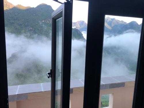 an open window with a view of the mountains at Homestay Huyền Thoại Cao Nguyên Đá in Lao Ou Tchai
