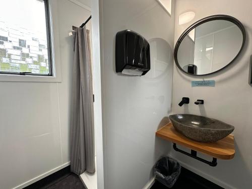 a bathroom with a sink and a mirror at Kiwi Cabins in Tapu
