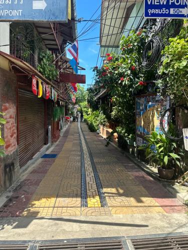 a street in a city with a train track at Bang sit Guest House in Phi Phi Don