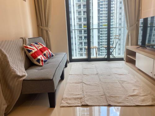 a living room with a couch and large windows at Local Living, Global Comfort 4 Pax Bangsar South in Kuala Lumpur