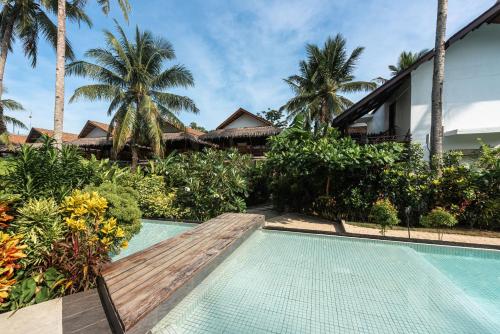 a swimming pool in front of a villa at Siargao Island Villas in General Luna