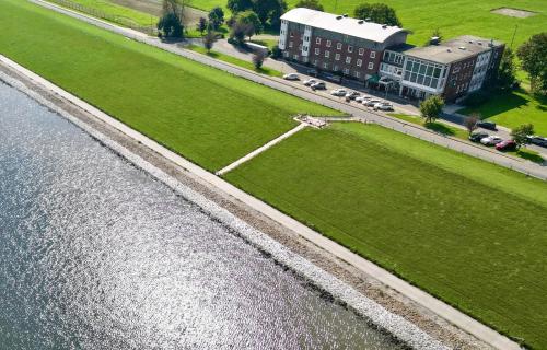 an aerial view of a building next to a body of water at Nordseehotel Wilhelmshaven in Wilhelmshaven