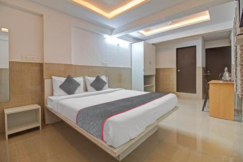 a bedroom with a large bed in a room at Super Townhouse 1266 Empire Executive in Pune