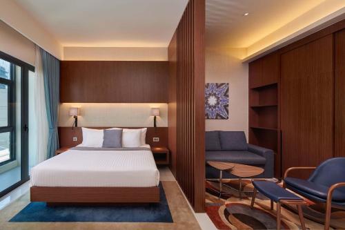 a hotel room with a bed and a couch at Tribeca Serviced Hotel by Millennium in Kuala Lumpur