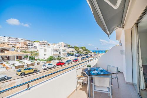 a balcony with a table and a view of a street at Can Botana Casa 8 - By Dream Villas Pollensa in Cala de Sant Vicenc