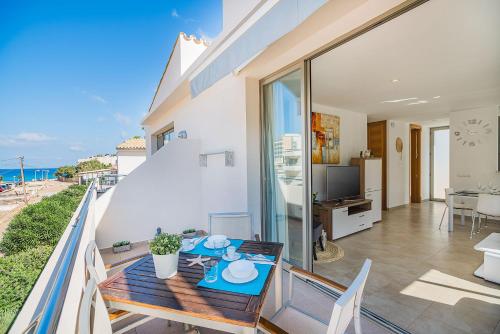 a dining room with a table and a view of the ocean at Can Botana Casa 8 - By Dream Villas Pollensa in Cala de Sant Vicenc