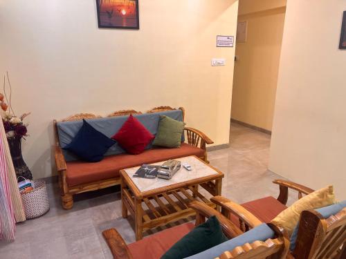 a living room with a couch and a table at Pinaki Comfort Stay, Vile Parle in Mumbai