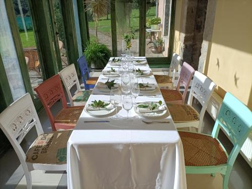 a long table with plates and wine glasses on it at Hotel Boutique Villa de Palacios - Palacio de Aras in San Miguel de Aras
