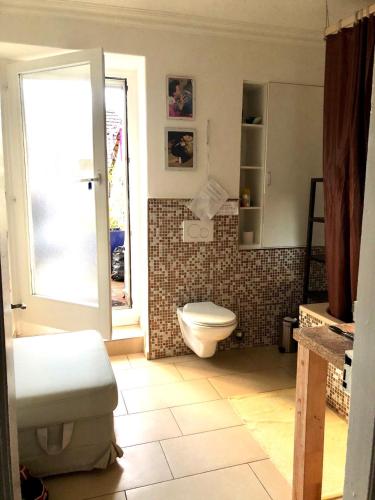 a bathroom with a toilet and a sink and a window at Zurich at the Lake double room in historic house shared Bath in Kilchberg