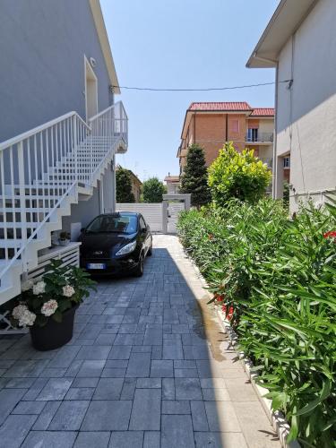 a car parked next to a house with a staircase at AlCivico3 in Civitanova Marche