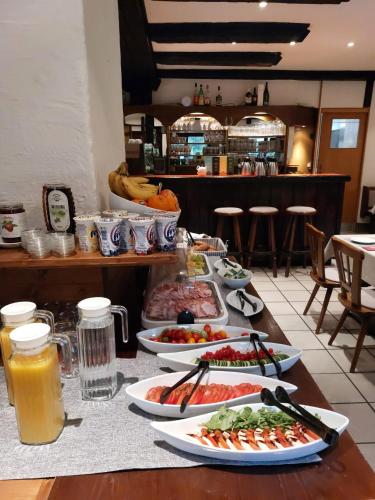 a table with many plates of food on it at Draxlerhaus in Hohentauern