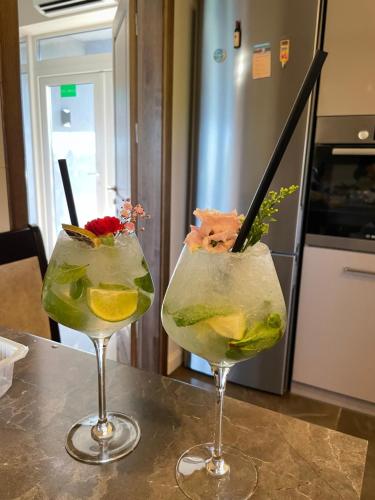 two cocktails in glasses sitting on a table at Villa Orchidea in Šakiai