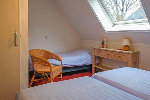 a bedroom with a desk and a bed and a window at opdehoekvandestal in Workum