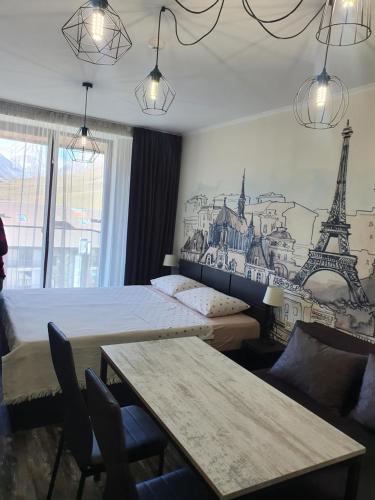 a bedroom with two beds and a mural of the eiffel tower at Frozen View New Gudauri in Gudauri