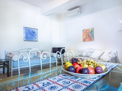 a bowl of fruit on a glass table in a room at Ollastu Apartments Villasimius in Villasimius