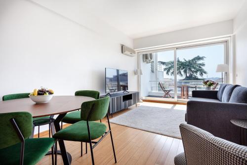 a living room with a table and green chairs at NOA - Sungu 1 in Istanbul