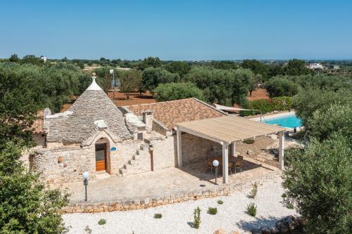 an aerial view of a house with a swimming pool at Trullo Fantastico in Castellana Grotte