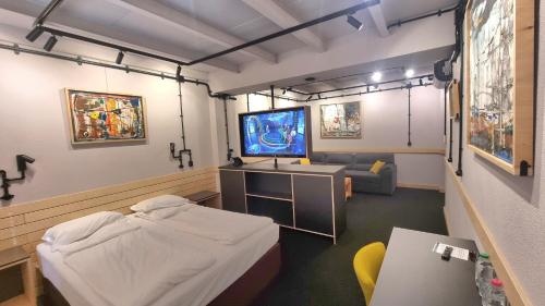 a hospital room with a bed and a flat screen tv at Art Hotel 158 in Sofia