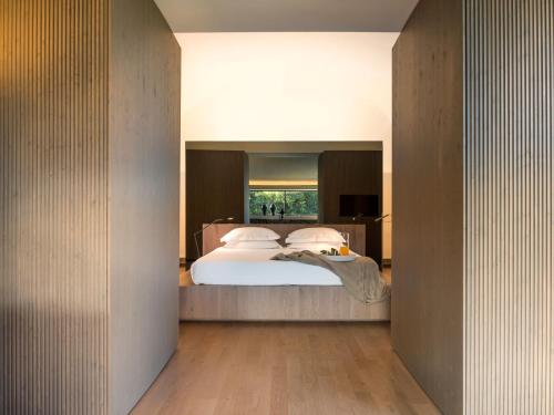 a bedroom with a bed with a large window at Zash Country Boutique hotel & SPA in Giarre