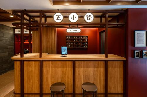 a bar in a restaurant with three chairs around it at Section L Ueno-Hirokoji in Tokyo