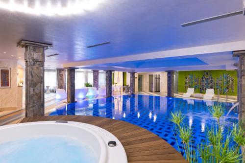 a large swimming pool with a tub in a building at Armaco Residence in Koprivshtitsa