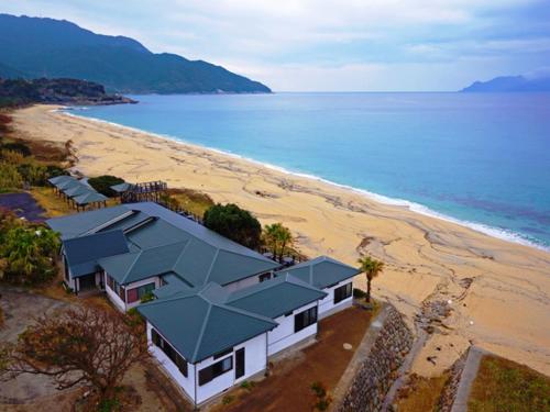an aerial view of a house on a beach at Marine Blue Yakushima in Yakushima