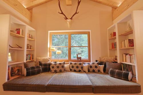 a living room with a large couch in front of a window at Haus Bödmenstein in Tschagguns