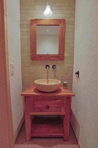 a bathroom with a sink and a mirror on a table at Haus Bödmenstein in Tschagguns