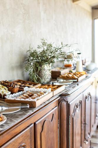 a buffet with many different types of food on it at Country House Oliveto sul Lago in San Nicolò