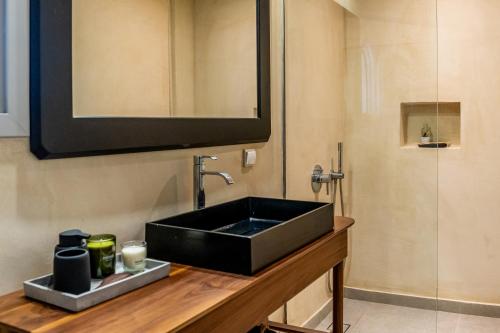 a bathroom with a black sink and a mirror at Marillia Village in Perivolos