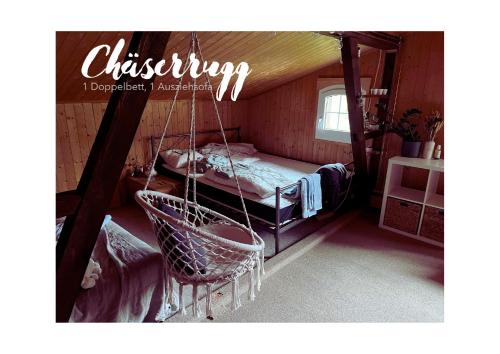 a room with a swing with a bed in it at Chalet Müsli in Wildhaus