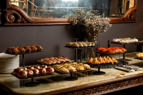 a display case with many different types of pastries at Hotel Atari in Donostia-San Sebastián