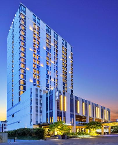 a large blue building with lights on at Anya Hotel Quy Nhon in Quy Nhon