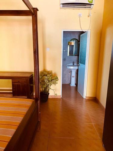 a room with a bed and a bathroom with a sink at Villa Elegance in Galle