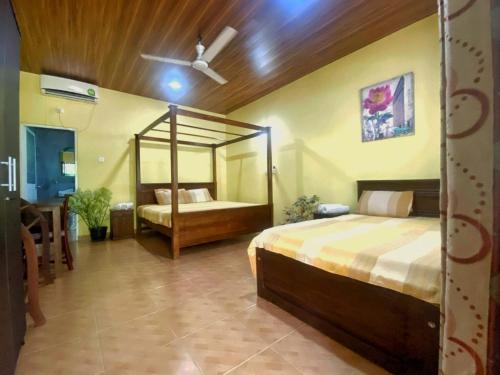 a bedroom with a large bed and a mirror at Villa Elegance in Galle