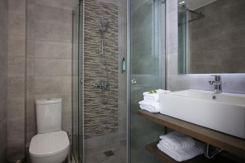 a bathroom with a toilet and a sink and a shower at Paradise Hotel Corfu in Gouvia