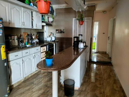 a kitchen with a island in the middle of a room at Haidar House a private rooms for men only at shared apartment غرف خاصه للرجال فقط in Alexandria