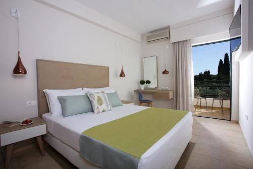 a bedroom with a large bed and a balcony at Paradise Hotel Corfu in Gouvia