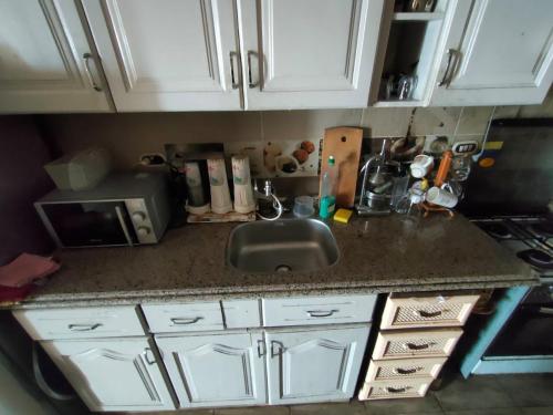 a kitchen counter with a sink and a microwave at Haidar Private bedroom for Men only غرف خاصه للرجال فقط 仅限男性 in Alexandria