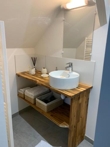 a bathroom with a sink and a mirror at Appart BOHEME in Château-Gontier