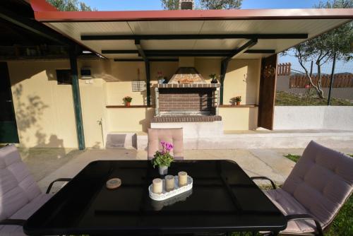 a black table with candles on it on a patio at Casa Frasta in Tzoumerka in Frásta
