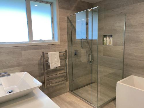 a bathroom with a glass shower and a sink at Prebbleton lifestyle Villa in Prebbleton