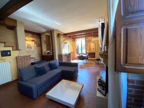 a living room with a blue couch and a table at Casa Chiara, roof terrace, 100m to the historical center in Lecce