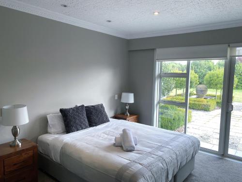 a bedroom with a bed with two stuffed animals on it at Prebbleton lifestyle Villa in Prebbleton