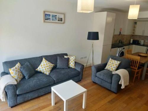 uma sala de estar com um sofá azul e uma mesa em BOURNECOAST: CLOSE TO SHOPS / SANDY BEACH -FM4034 em Bournemouth