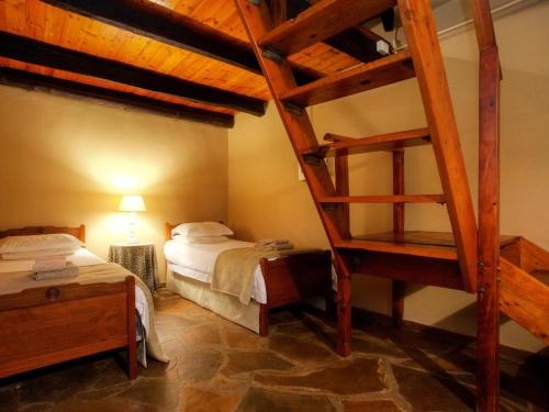 a bedroom with two bunk beds and a ladder at Zandvlakte Guest Farm in Studtis