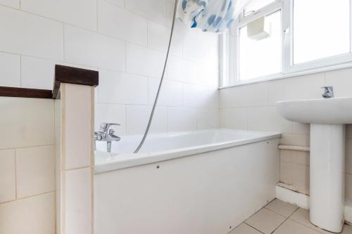 a bathroom with a sink and a bath tub at Well located 1 bed Angel/Kings Cross pad in London